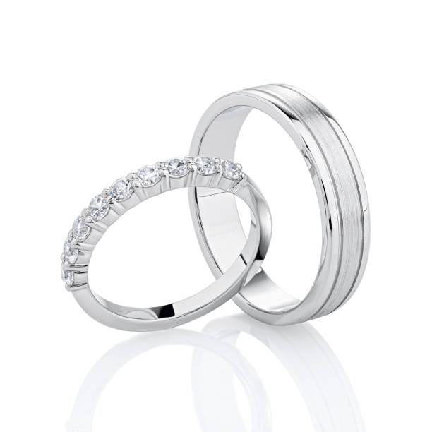 istock Pair of silver wedding rings isolated on white background. 1202808698