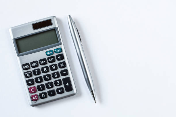 istock calculator and pen isolated on white background 1202809948