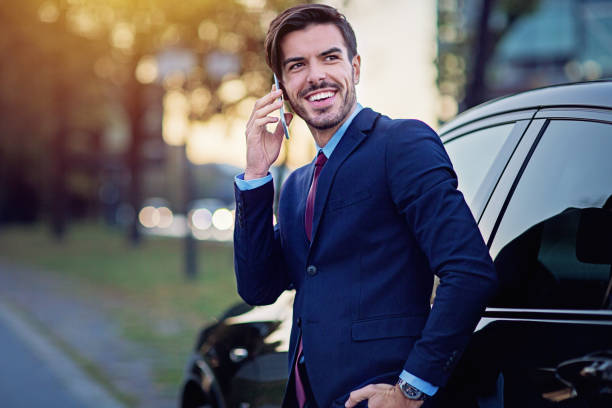 istock Businessman is talking next to his car 1202810386