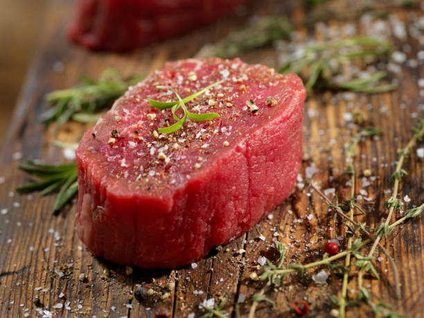 seasoning raw fillet mignon steaks - fat portion studio shot close up imagens e fotografias de stock