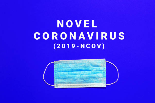 istock Coronavirus outbreak. Medical mask on a red background with text. 1202812720
