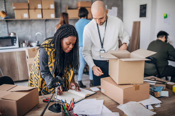 istock Diverse group of people arranging customers orders for drop shipping 1202812919