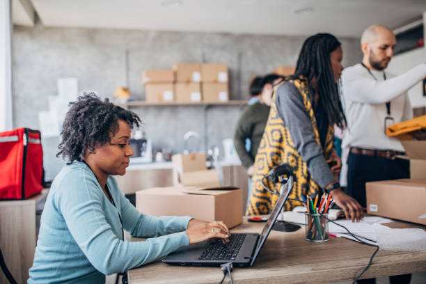 istock Diverse group of people arranging customers orders for drop shipping 1202813174