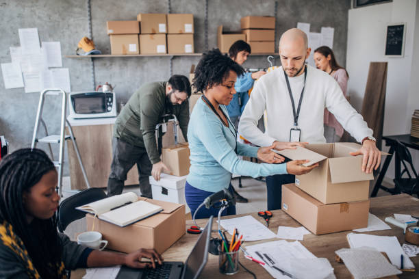 istock Diverse group of people arranging customers orders for drop shipping 1202813264