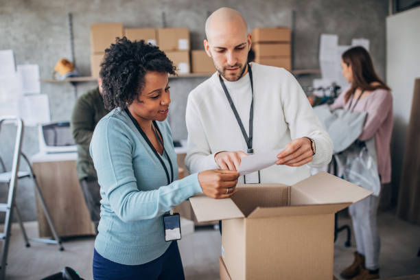 istock Diverse group of people arranging customers orders for drop shipping 1202813352