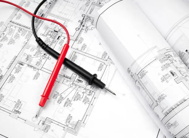 High angle view on the plan of electrical installation and cables of multimeter