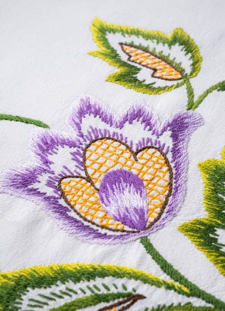 istock Fantasy flower embroidered with stitch on white linen natural fabric. 1202814832