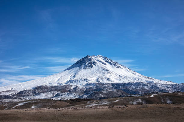 Peak of Snowy Volcano Mount Hasan over blue cloudy sky Middle Anatolia Turkey Peak of Snowy Volcano Mount Hasan over blue cloudy sky Middle Anatolia Turkey cappadocia winter photos stock pictures, royalty-free photos & images