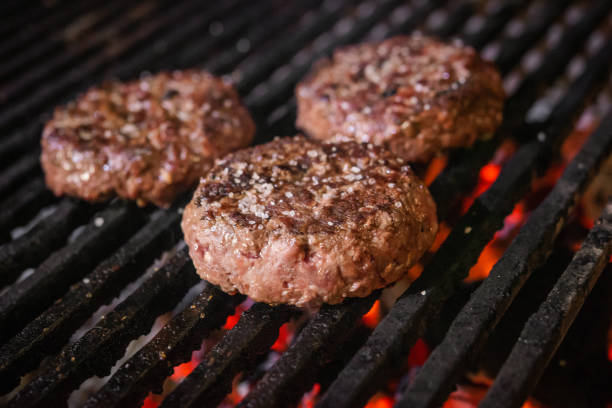 istock Grilled hamburgers on charcoal coals 1202815730