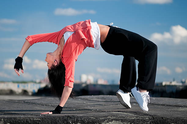 istock woman dancing hip hop over blue sky 120281581