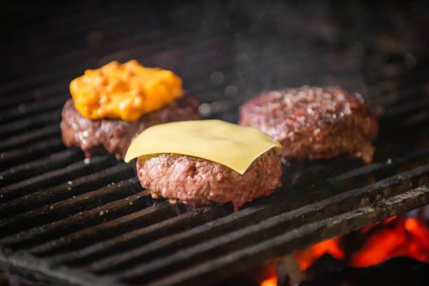istock Grilled hamburgers on charcoal coals 1202815866