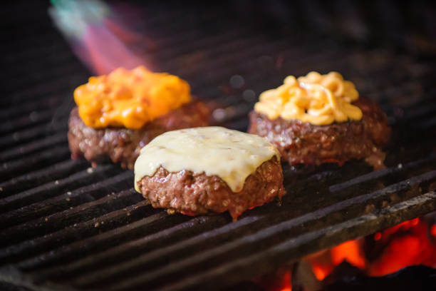 istock Grilled hamburgers on charcoal coals 1202815872