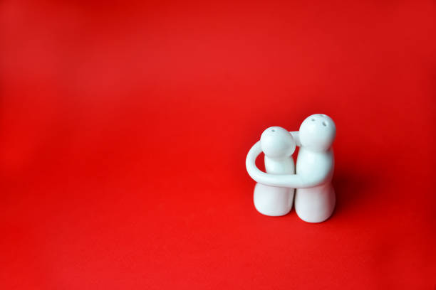 istock white figures in a hug on a red background. valentines day concept 1202816189