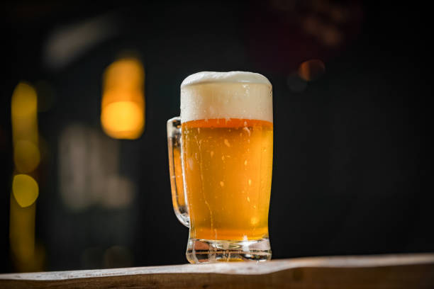 istock mug full of chopp, with chopp pilsen on a rustic table 1202816856