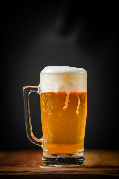 istock mug full of chopp, with chopp pilsen on a rustic table 1202818525
