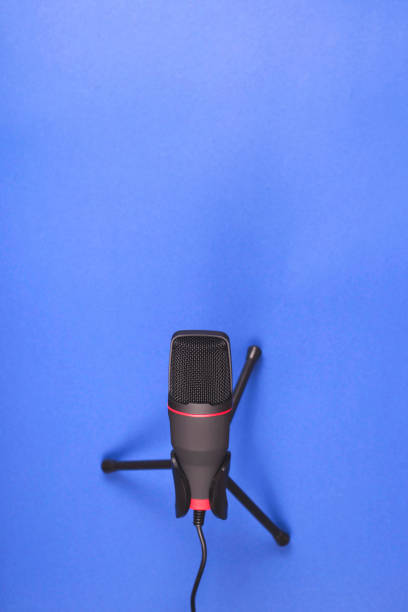 istock Microphone for recording sound and podcasts on blue. 1202818561