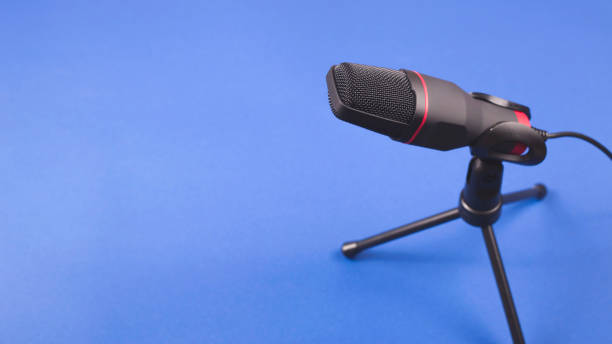 istock Microphone for recording sound and podcasts on blue. 1202818566
