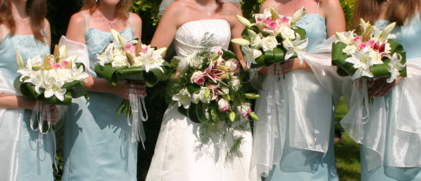 istock bridge and brides maid with flowers 1202818692