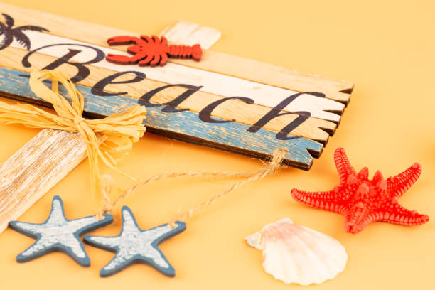 istock Wooden sign beach, starfish and shell 1202820834