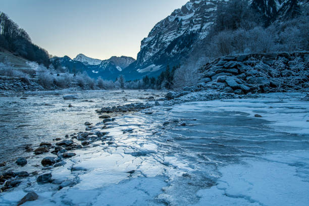 A cold winter morning at a partially frozen river in Mellau at the Bregenzerwald, Voralberg, Austria.