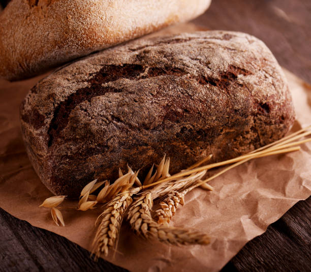 istock Fresh baked bread with on an old wooden table 1202824755