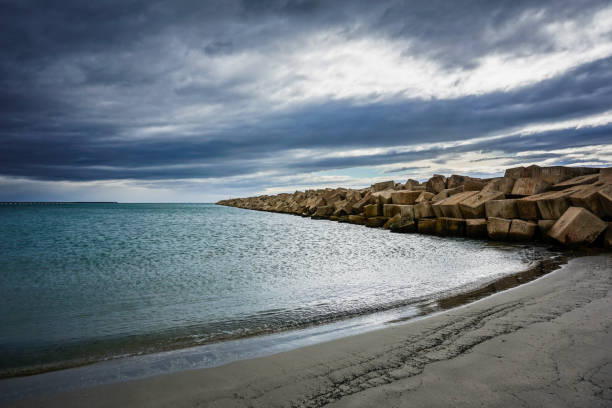 Moody Beach with wave barrier with bad weather