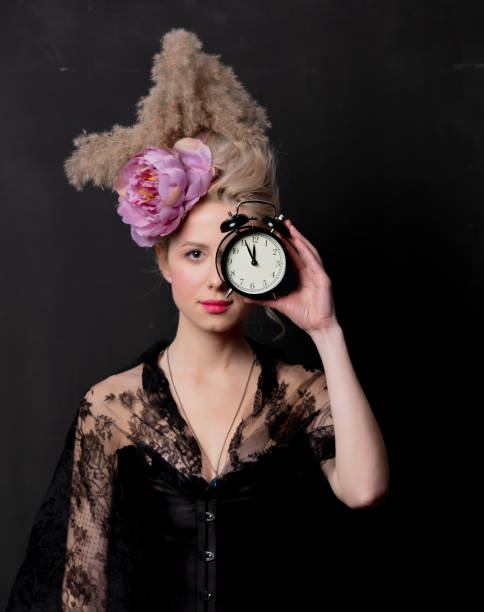 istock Beautiful blonde countess with alarm clock 1202826584