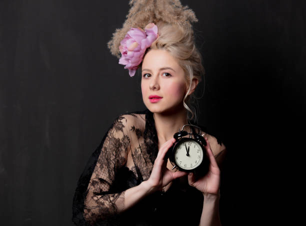 istock Beautiful blonde countess with alarm clock 1202826597