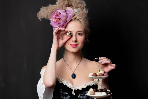 istock Beautiful blonde countess with chocolate candies 1202826780