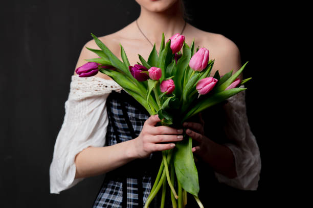 istock Beautiful blonde countess with tulips 1202826781