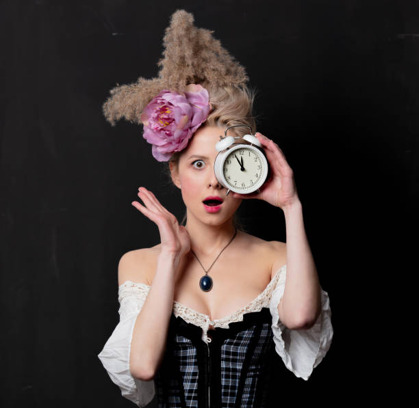 istock Beautiful blonde countess with alarm clock 1202826794