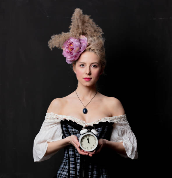istock Beautiful blonde countess with alarm clock 1202826806