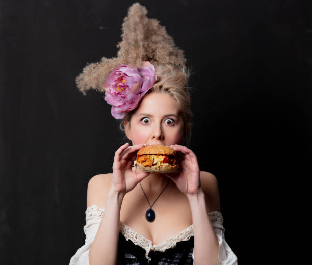 istock Beautiful blonde countess with a burger 1202826851