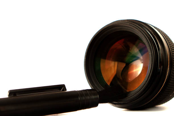 Abstract macro image depicting reflection and refraction on the front glass element of a camera lens.