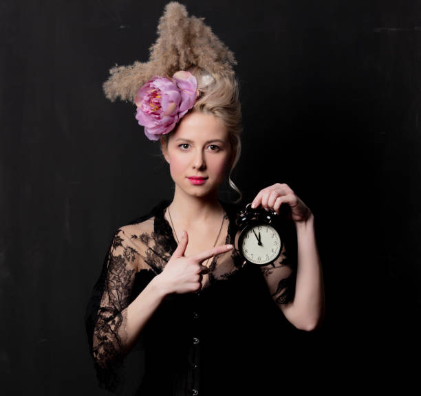 istock Beautiful blonde countess with alarm clock 1202826959