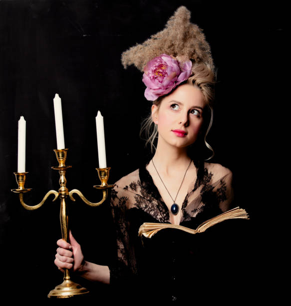 красивая блондинка графиня с книгой и подсвечником - baroque style costume corset women стоковые фото и изображения