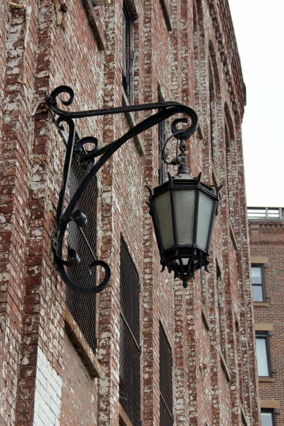 istock Vintage-styled lantern on a brick wall, New York 1202833646