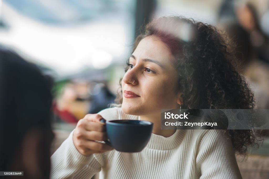 Friends in Coffee Shop Young people get together in a coffeeshop. 20-29 Years Stock Photo