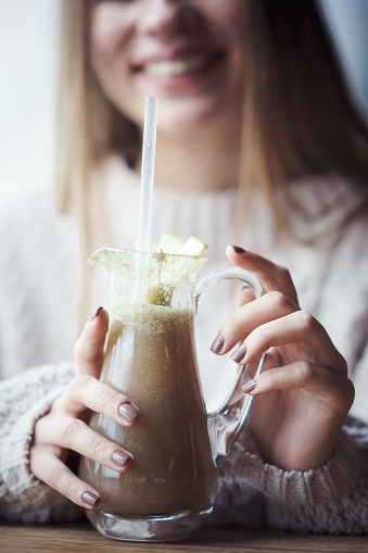 Young woman holding a detox smoothy