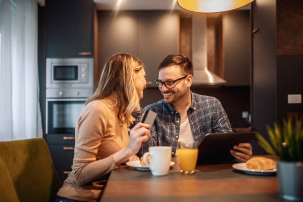 istock Beautiful smiling young couple having breakfast at home 1202835486