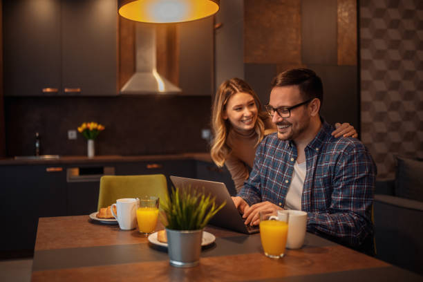 istock Beautiful smiling young couple having breakfast at home 1202835610