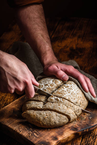 istock Slicing homemade rye bread 1202842797