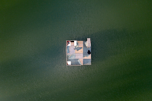 Abstract image of a floating platform on a lake viewed directly from above.