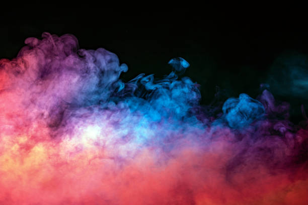 istock Abstract backlit smoke texture in red blue yellow on a black background. 1202845695