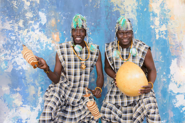 istock African artists with traditional musical instruments on blue wall background. 1202847322