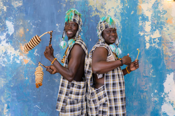 istock African artists with traditional musical instruments on blue wall background. 1202847326