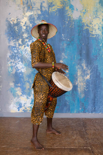 istock African man in traditional clothes playing djembe drum 1202847334