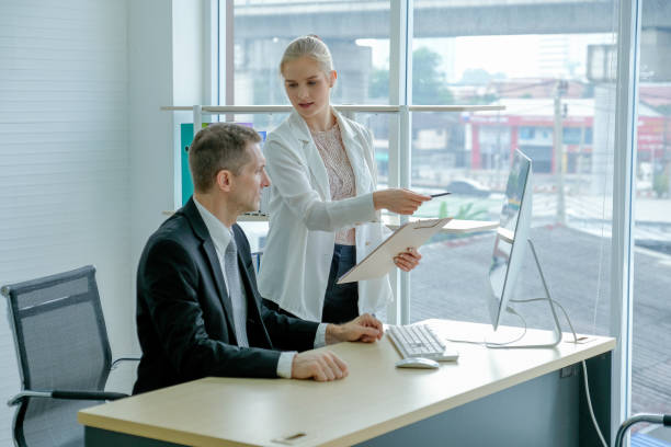 istock Young secretary discuss with manager by point to the computer screen 1202849119