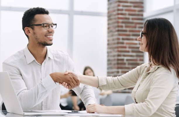 istock close up. young business partners shaking hands. 1202853635