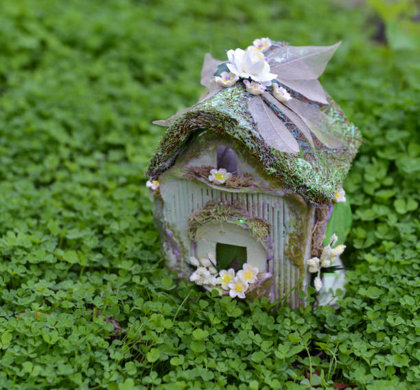 istock Beautiful tiny fairy cottage in clover field. 1202856147